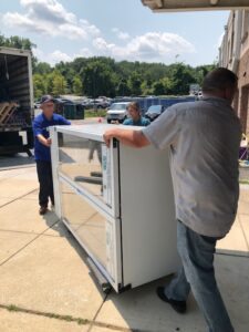 picture of new refrigerators being delivered to Baltimore police districts